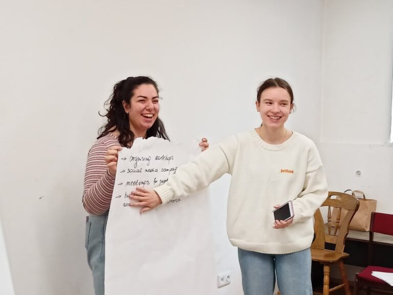 two girl ltv in Poland holding a poster