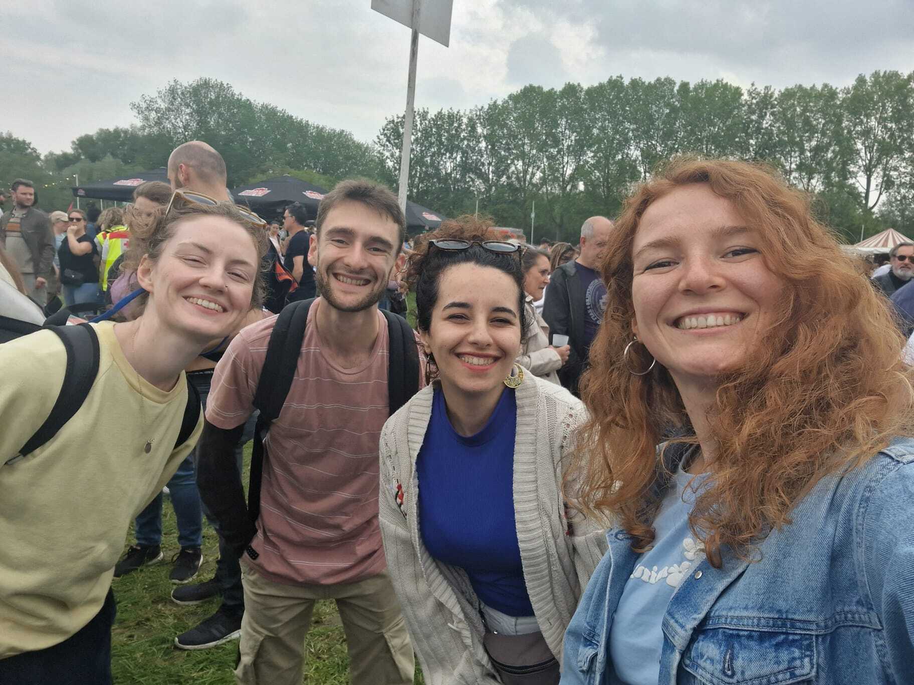 Four young people smiling at a festival