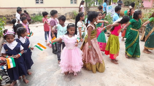 APM closing ceremony, kids dancing and waving indian flags