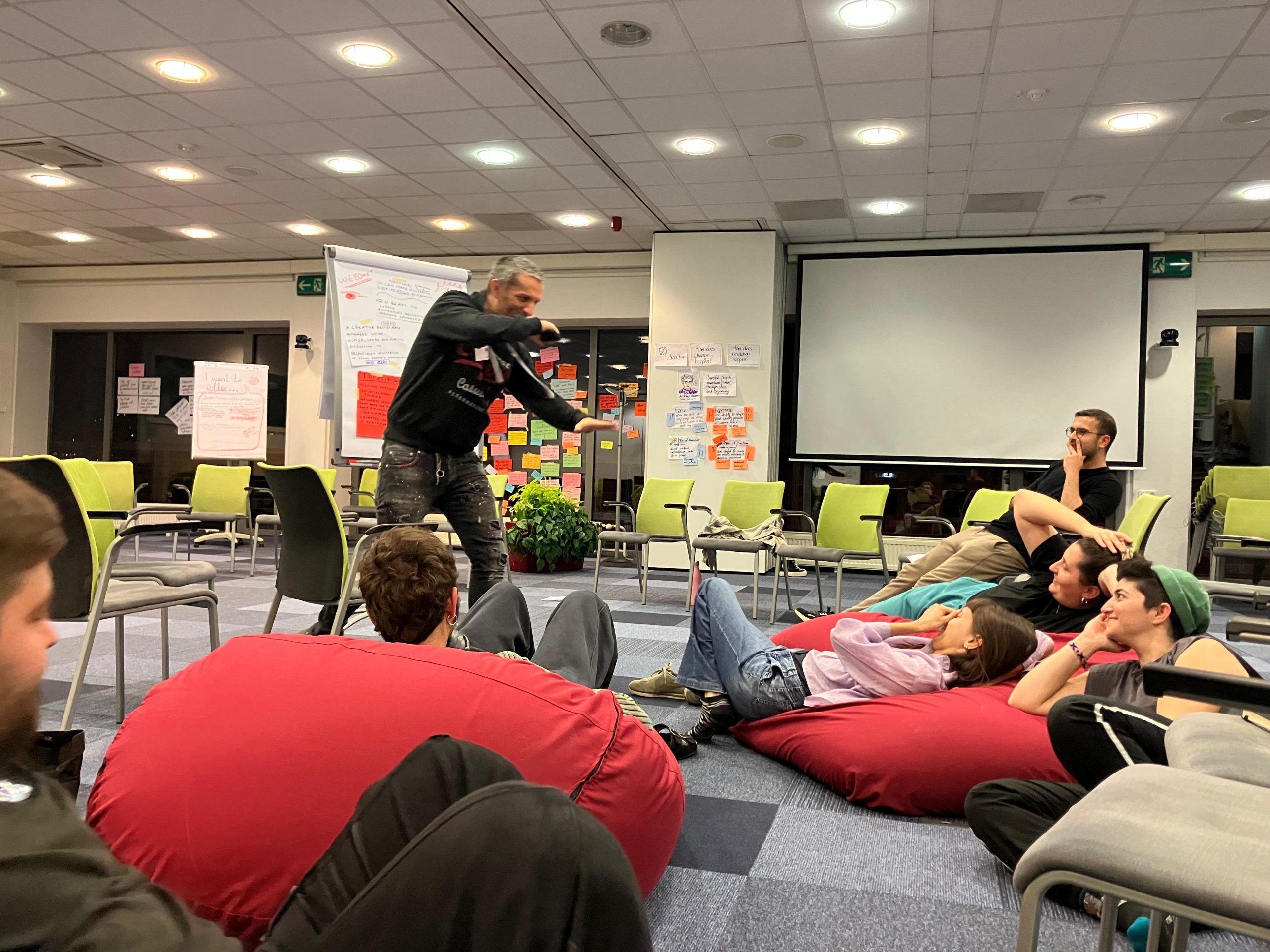 Picture of Stavros holding a discussion about humor as a tool in political activism, taken by Kerry