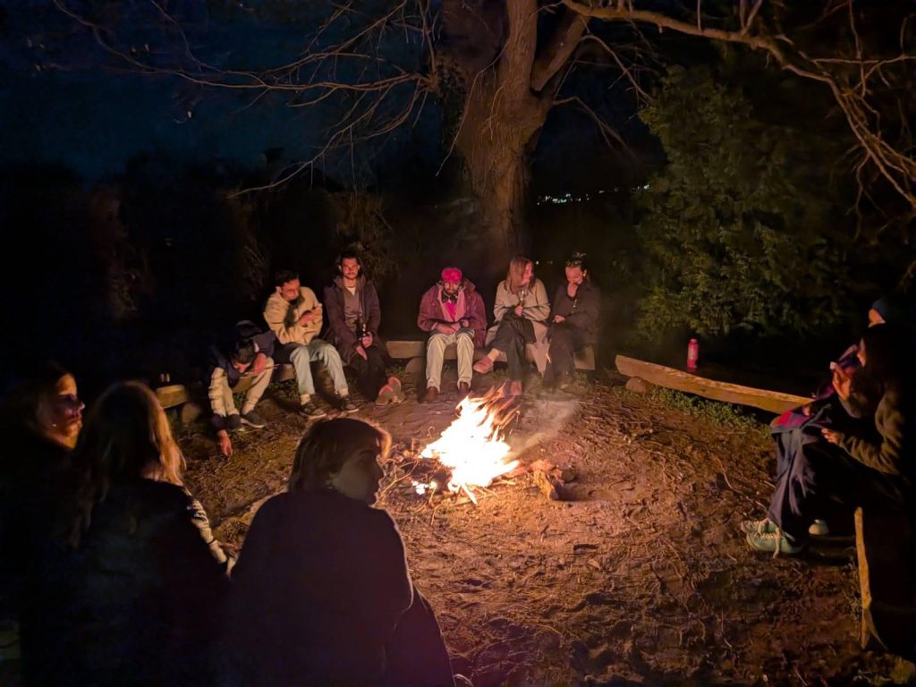 participants from FLOW sitting around a campfire