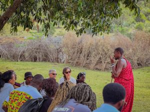 A Masai man talking to a group