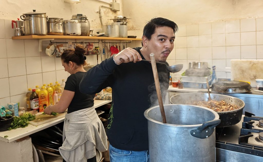 Someone stirring a pot in the kitchen