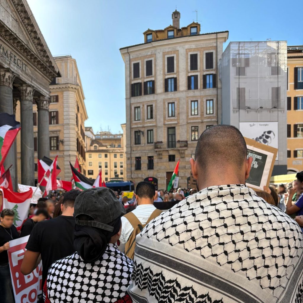 Two people wearing a Keffiyeh at a protest