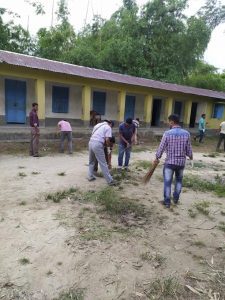 People cleaning the school compound