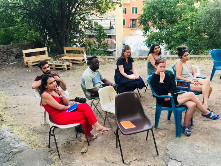 People sitting and listening to someone outside of the picture frame