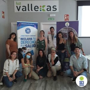 Volunteers in front of banners about "Derecho a la salud"