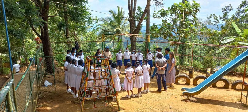 Some students and their teacher in a circle