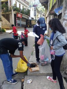 people picking up trash in the streets