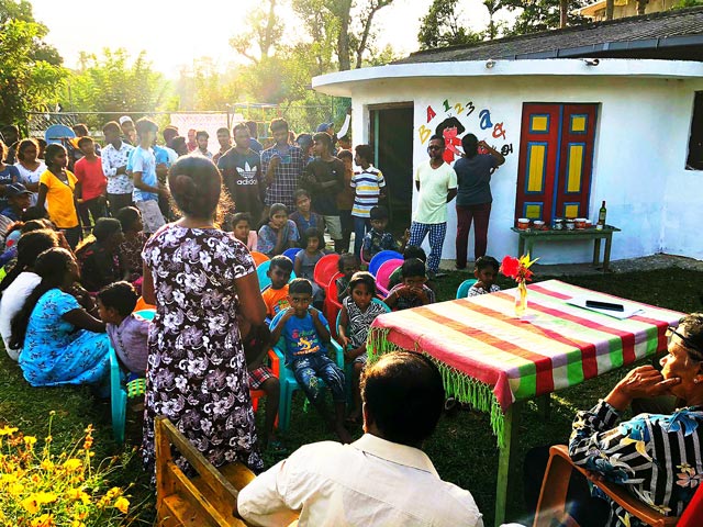 Kids, teachers, parents in front of a school building ready for a meeting