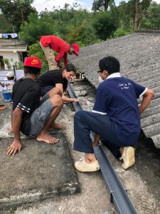 4 people working on a roof