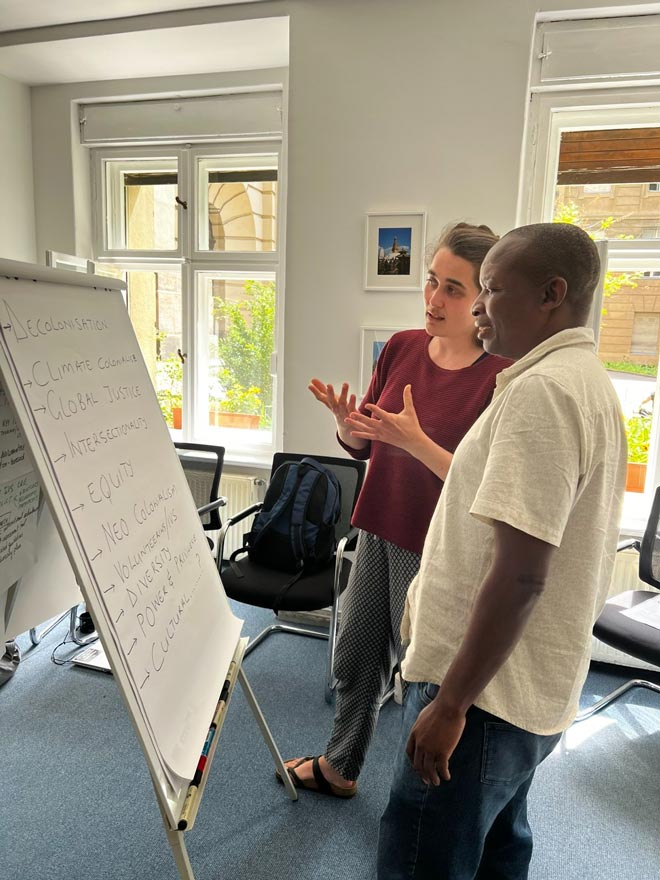 One woman and one man discussing what is written in the board 