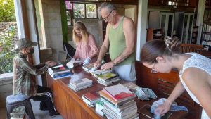 Volunteers cleaning and recording the books