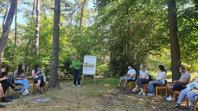 Participants having a discussion in nature 