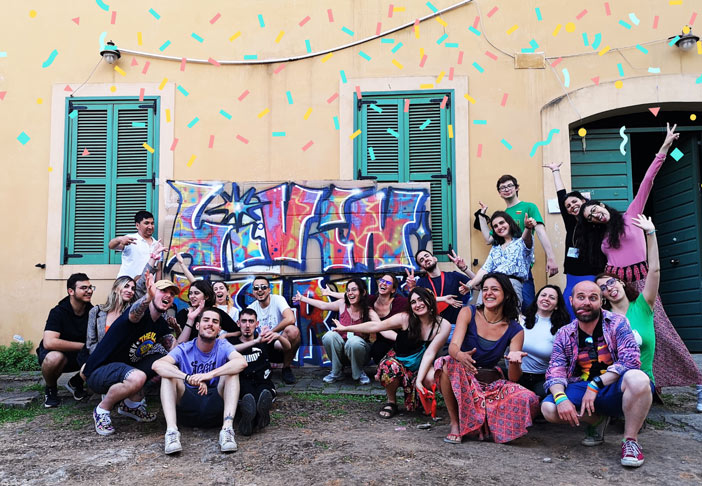 youth sitting in the floor smiling for a picture