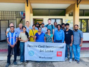 Staff and volunteers in Sri Lanka holding an SCI banner